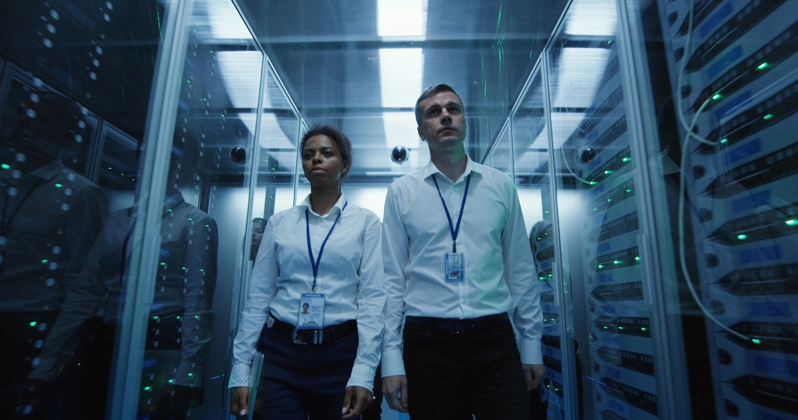 Professionals walking through a modern data centre