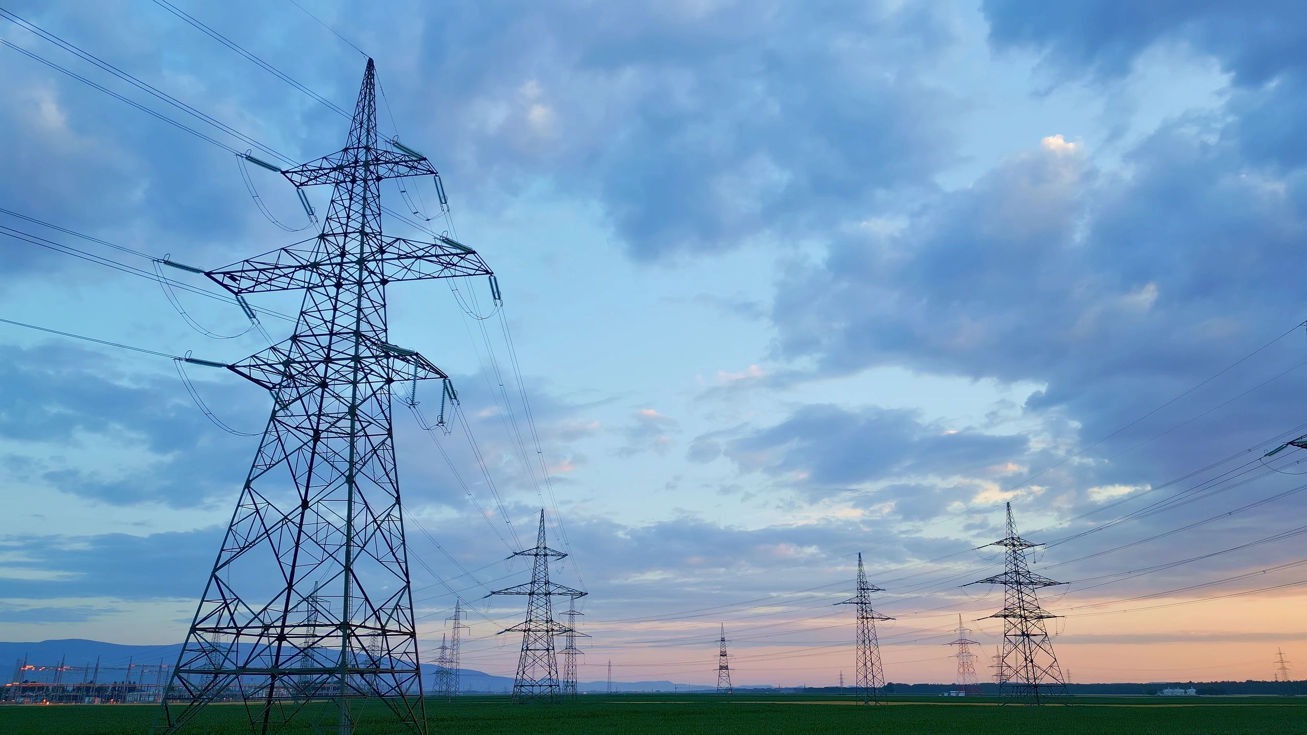 Power lines and grid infrastructure at dusk